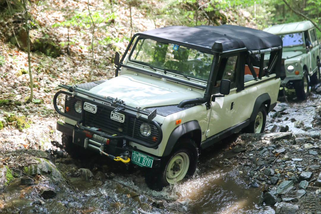 Land Rover crossing mountain stream.