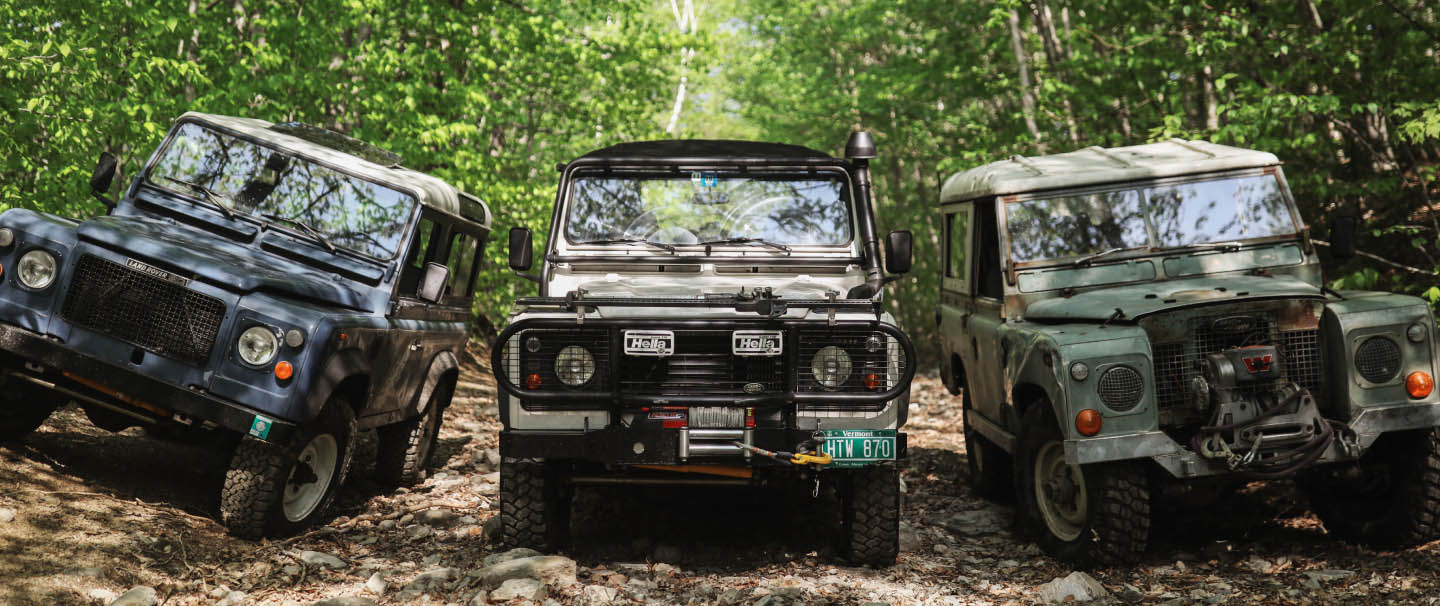 Three vintage Land Rovers.